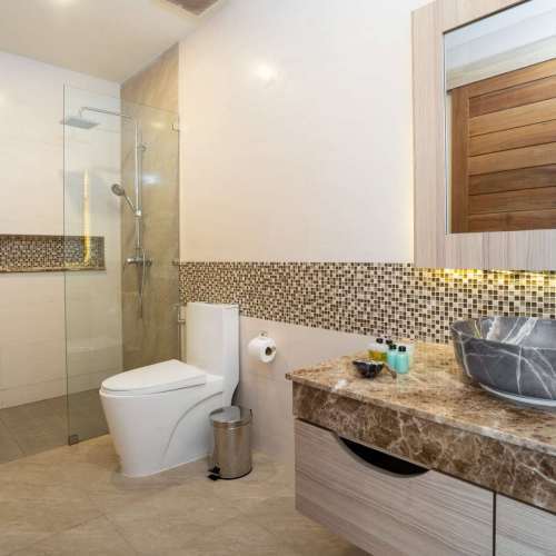 sink-with-top-granite-toilet-and-shower-in-a-house-min